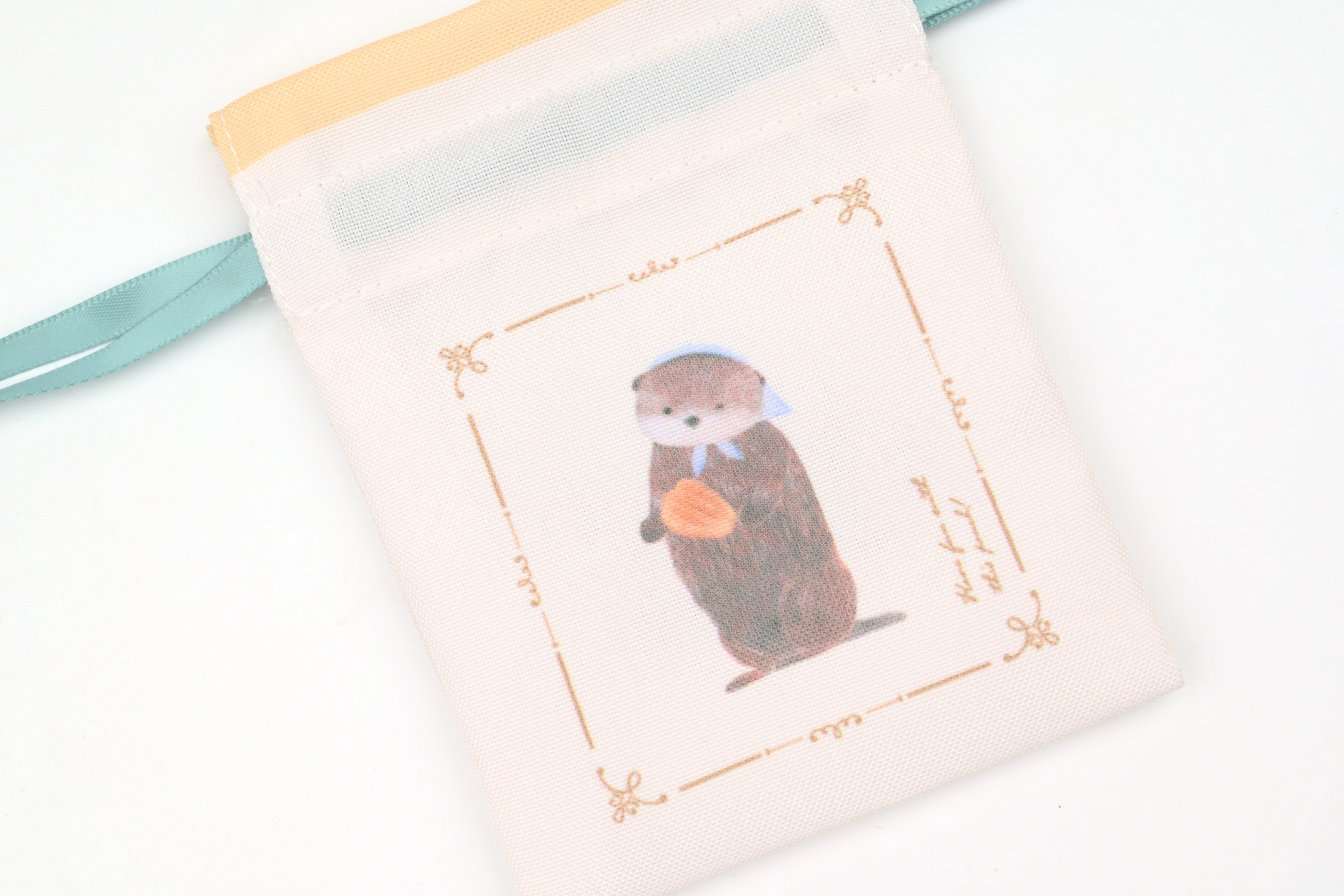 NB Mini Drawstring Pouch - Ressa - A Sea Otter and Shell Madeleines